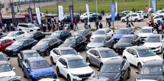 Rows of new hybrid and electric SUVs on display at the Abuja Motor Fair