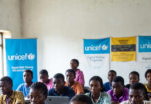Nigeria Faces Digital Skills Emergency, Warns UNICEF Nigerian students in a classroom with laptops and UNICEF digital skills banners, highlighting the urgent need for tech education