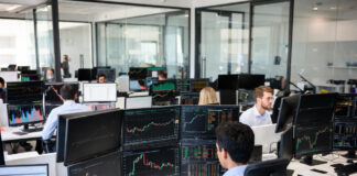 Trader analyzing declining stock charts on multiple screens with headline overlay: "Awareness Gap Stalls NGX Tech Listings".