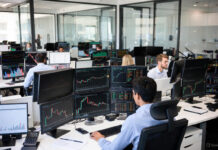 Food Bank Unveils Technology to Combat Hunger Nationwide Diverse group of professionals in a modern conference room watching a presentation titled "Food Bank Technology Initiative – Combating Hunger Nationwide" with data charts and laptops on the table