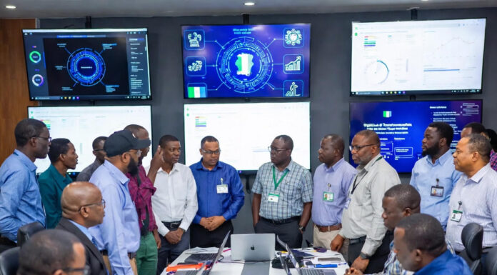 FIRS officials and experts gather in a high-tech command center during the MARCON Retreat, surrounded by large digital screens displaying tax data, analytics, and Nigeria-focused tech solutions.