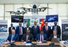 Caverton and Chinese university officials sign an MoU at a formal ceremony, surrounded by advanced UAV prototypes, Nigerian and Chinese flags, and digital drone displays.
