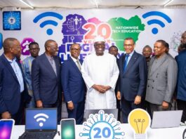 Diverse group of Nigerian tech leaders, entrepreneurs, and developers in a modern office brainstorming around laptops and data charts, symbolizing Nigeria’s ambition to lead Africa in AI innovation.