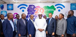 Diverse group of Nigerian tech leaders, entrepreneurs, and developers in a modern office brainstorming around laptops and data charts, symbolizing Nigeria’s ambition to lead Africa in AI innovation.