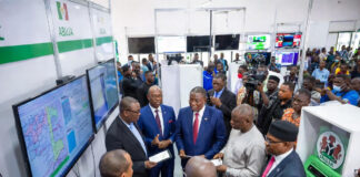 INEC officials and citizens celebrate the unveiling of biometric voting machines and digital result systems in Abuja.