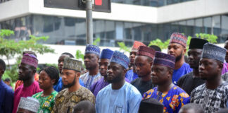 Nigerian tech leaders stand united under glowing digital screens, with shadowy global tech giants looming in the background.