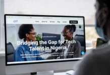Bottomline Assist Bridges Gap for Tech Talent in Nigeria Nigerian tech founder and recruiter smiling at a large monitor displaying the Bottomline Assist platform with the headline “Bridging the Gap for Tech Talent in Nigeria” and profiles of skilled developers.