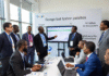 Google Unveils N3 Billion Initiative to Transform Nigeria’s AI Ecosystem and Digital Security Infrastructure Google executives and Nigerian government officials in a modern conference room unveiling the ₦3 billion AI and digital security initiative, with a presentation screen showing data charts and the Google log
