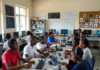 Robotics and Coding Classes Transform Nigeria’s Education System Nigerian school children in uniforms excitedly building robots and coding on computers in a bright classroom filled with circuit boards, laptops and moving robotic projects.