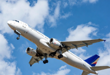 ‘Behaviour, not technology, defines Nigeria’s aviation outlook’ A Nigerian commercial jet taking off against a clear blue sky, with a subtle overlay of a cracked safety checklist and human silhouette, symbolising that human behaviour remains the biggest factor in aviation safety and efficiency.