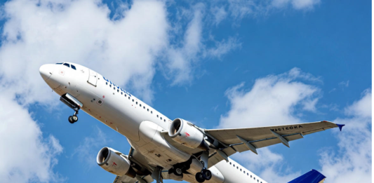 ‘Behaviour, not technology, defines Nigeria’s aviation outlook’ A Nigerian commercial jet taking off against a clear blue sky, with a subtle overlay of a cracked safety checklist and human silhouette, symbolising that human behaviour remains the biggest factor in aviation safety and efficiency.