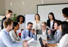 Nigeria Moves to Update National Biotechnology Policy Nigerian government officials, researchers, and experts gathered in a modern conference room discussing biotechnology policy updates, with screens showing biotech innovations like GM crops and lab equipment.