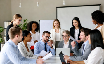 Nigeria Moves to Update National Biotechnology Policy Nigerian government officials, researchers, and experts gathered in a modern conference room discussing biotechnology policy updates, with screens showing biotech innovations like GM crops and lab equipment.