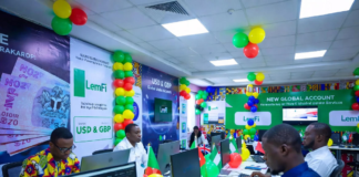 LemFi Launches USD & GBP Global Accounts in Nigeria Excited Nigerians at a colourful launch event with green, white and yellow balloons, using laptops to open LemFi USD and GBP global accounts on the app.