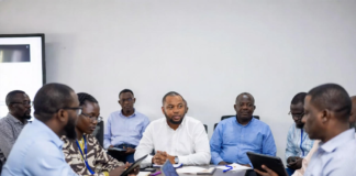 Lagos State Governor and Russian officials shaking hands in front of Nigerian and Russian flags, with digital overlays of power grids, renewable energy plants and smart city technology.