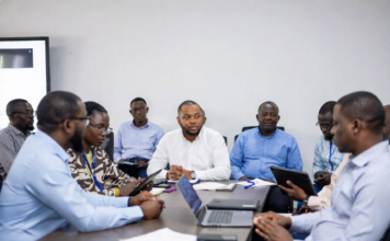 Lagos Government Partners with Russia to Enhance Energy and Technology Sectors Lagos State Governor and Russian officials shaking hands in front of Nigerian and Russian flags, with digital overlays of power grids, renewable energy plants and smart city technology.