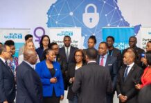 UN Women Advocates Partnerships to Tackle Digital Gender Violence UN Women representatives, Nigerian officials, and activists stand together at a Lagos summit in front of a digital Africa map with shields and locks, symbolizing the fight against online gender violence.