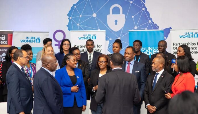 UN Women representatives, Nigerian officials, and activists stand together at a Lagos summit in front of a digital Africa map with shields and locks, symbolizing the fight against online gender violence.