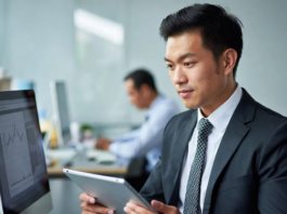 Nigerian tech recruiters and company founders smiling while reviewing profiles of pre-vetted software engineers, data scientists and product managers on laptops in a modern Lagos office.