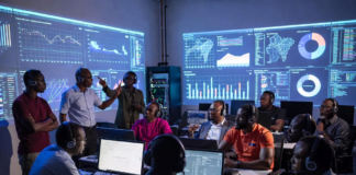 Nigerian cybercrime investigators and law enforcement officers wearing headsets in a futuristic command centre, tracking dark-web trafficking networks and cryptocurrency trails on massive glowing screens.