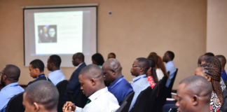 Nigerian investigators, prosecutors and law enforcement officers in a training workshop, attentively taking notes while learning digital forensics and online trafficking investigation techniques.
