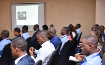 Nigerian investigators, prosecutors and law enforcement officers in a training workshop, attentively taking notes while learning digital forensics and online trafficking investigation techniques.