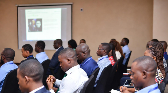 Nigerian investigators, prosecutors and law enforcement officers in a training workshop, attentively taking notes while learning digital forensics and online trafficking investigation techniques.